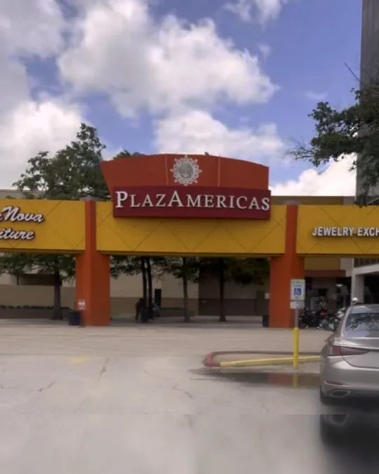 The Bellaire-side PlazAmericas entrance — arches between SuperNova Furniture and the Jewelry Exchange Center, next to Melrose