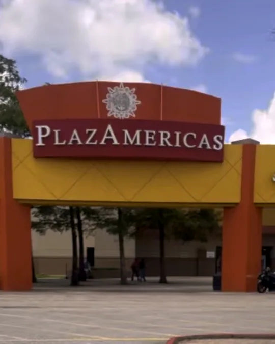The PlazAmericas entrance arches from the parking lot