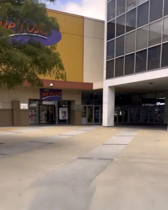 Both mall entrances side by side — use the doors under the my Melrose sign, to the left of the glass tower