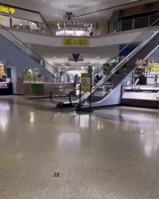 The central escalator between the kiosks, up to the second floor