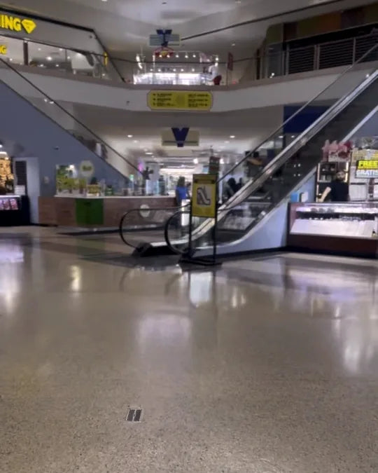 The central escalator between the kiosks, up to the second floor