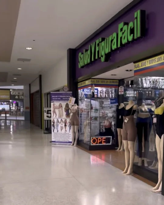 At the top of the escalator turn left — the second-floor walkway with the storefront wall bending right